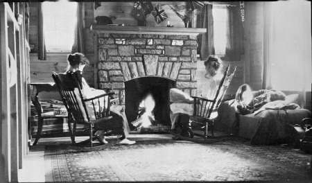 Figures around fireplace at Boyd Cottage